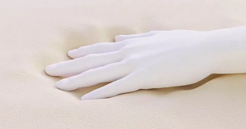 The hand presses on the memory foam bed of the orthopedic mattress Stock Footage 210809525