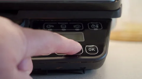A hand presses the plastic control buttons on the electric grill's panel. Stock Footage 320890244