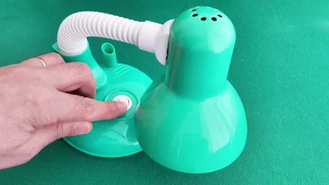 Hand Presses Power Button on Green Desk Lamp with Flexible Neck Vídeos de archivo 328698630