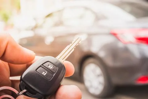 Hand presses on the remote control car alarm. Stock Photos
