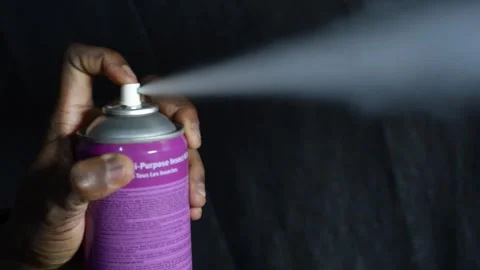 Hand pressing aerosol bug spray Stock Footage 277435307