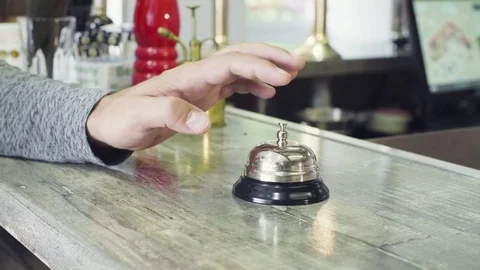 Hand pressing the bell button to call the waiter Video stock 80143061