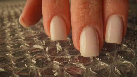 Hand Pressing Bubble Wrap for Relaxation and Stress Relief Stock Photos