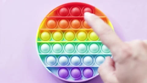 Hand pressing bumps on pop it toy Stock Footage 159172322