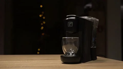 Hand pressing button to brew tea with machine Stock Footage 144440717