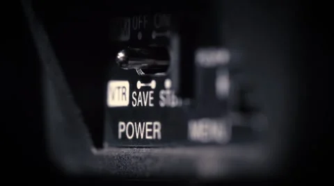 Hand pressing ON-OFF button on television camera Stock Footage 58140163