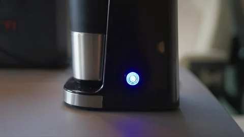 Hand Pressing Button to Turn On Portable Coffee Machine Close-Up Stock Footage 334588929