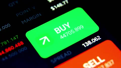 Hand pressing BUY button in online crypto currency or stock trading broker Stock Footage