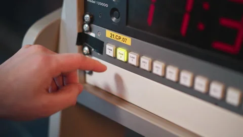 Hand pressing cam 1 button on broadcast control panel with timer display Stock Footage 317537976
