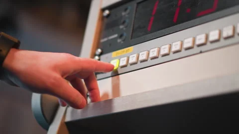 Hand pressing cam 2 button on broadcast control panel with timer display Stock Footage 317538232