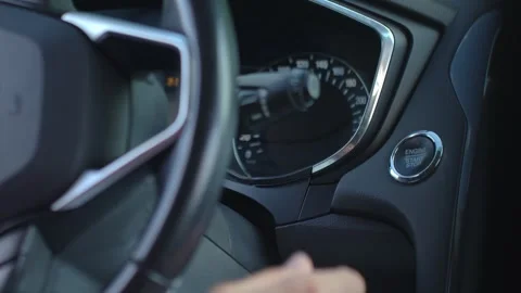Hand pressing car engine start button inside modern vehicle Stock Footage 313464929