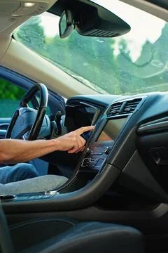 Hand pressing car engine start button inside vehicle Stock Photos