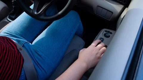 Hand pressing a car window lock button. driver is pressing buttons of windo.. Photos