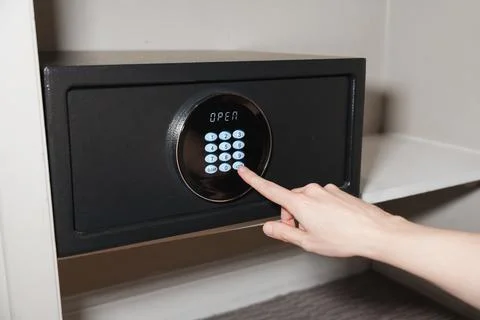 Hand Pressing Code On Digital Hotel Safe Stock Photos