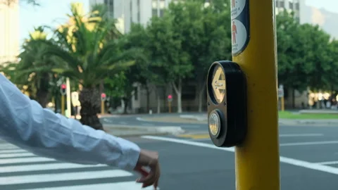 Hand pressing crosswalk button to cross the road. Crossing street safely. Stock Footage 277085412