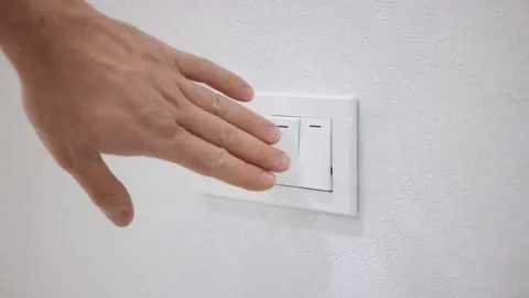 Hand pressing electronic-light switch. Close-up. Stockbeeldmateriaal 150331915