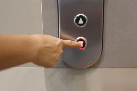 Hand Pressing Elevator Button in Modern Building Foto stock