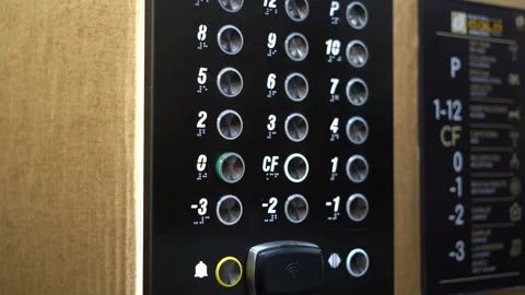 Hand pressing floor button on modern elevator control panel Stock Footage 343014344