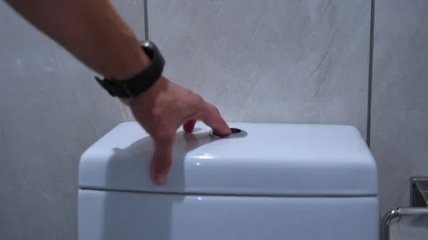 Hand Pressing Flush Button on Toilet – Clean Hygiene Action Close-Up Video stock 312207842