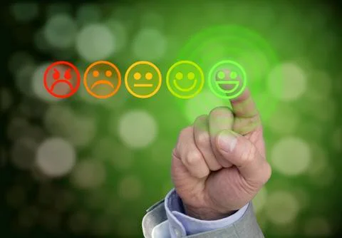Hand pressing green smiley button of performance rating Stock Photos