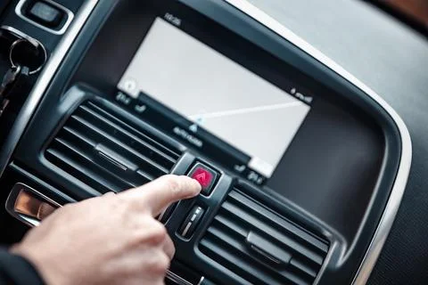 Hand pressing Hazard warning lights button, red triangle button in car. War.. Stock Photos