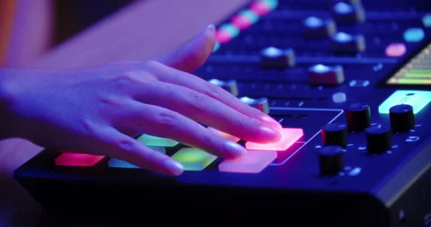 Hand pressing illuminated button on audio controller Stock Footage 315515989