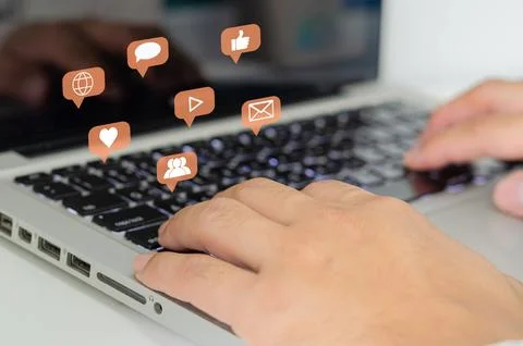 Hand pressing the keyboard of a laptop computer. Icon virtual interface tec.. Stock Photos