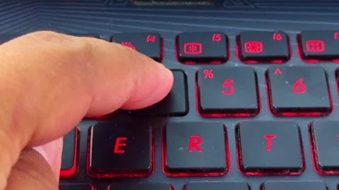 Hand pressing laptop keyboard button in 4, close-up showing typing action and Stock Footage 333892293
