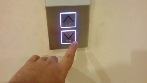 Hand pressing lift button Stock Footage 145841919