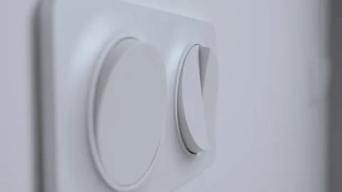 Hand pressing light switch to turn on lighting Stock Footage 324659177