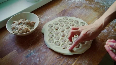 Hand pressing minced meat into dumpling mold filled with dough. Fingers Stock Footage 303094108