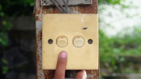 Hand pressing the outdoor light switch button. Stock Footage 310114794
