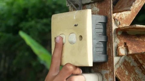 Hand pressing the outdoor light switch button. Stock Footage 310114797