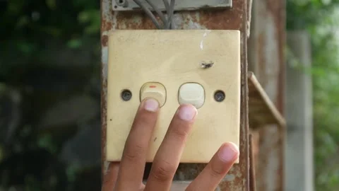 Hand pressing the outdoor light switch button. Stock Footage 310114799