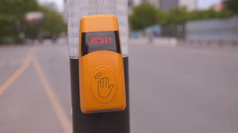 Hand pressing pedestrian crossing button at a crosswalk 動画素材 337644877