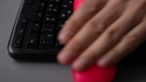 Hand pressing pink cleaning slime on dusty black keyboard to remove dirt Stock-Footage 342785568