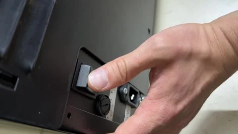 Hand pressing power switch on electronic device, turning appliance on or off, Stock Footage 335694835