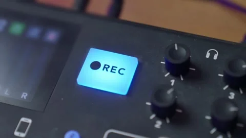 Hand pressing on REC button to begin recording and then clicking again to stop Stockbeeldmateriaal 298175886