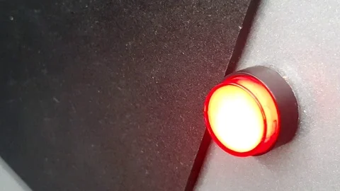 A hand pressing a red button and lighting it up for a few seconds three times Stock Footage 107199735