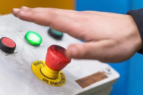 Hand pressing the red emergency button or stop button for industrial machi... Stock Photos