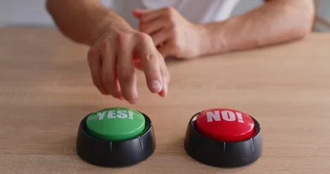 Hand pressing red NO button beside green YES option on wooden table in closeup Stock Footage 315452320