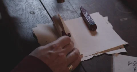 Hand Pressing a Red Wax on a Scroll Then Stamps to Seal It 動画素材 156198803