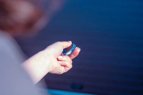 Hand pressing remote control to open automatic garage door Stock Photos