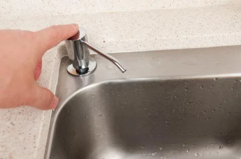 Hand pressing sanitizer Stock Photos