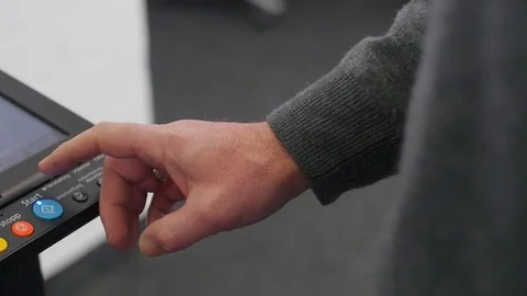 Hand pressing Start button on copy machine Stock Footage 74215669