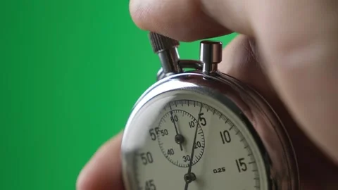 Hand pressing a stopwatch button against a green screen background Video stock 344331441