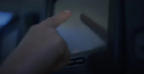 Hand pressing touch screen in airplane seat TV Stock Footage 223349115