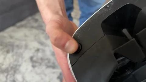 Hand pressing VR power button on appliance, switching virtual reality device on 動画素材 337121136