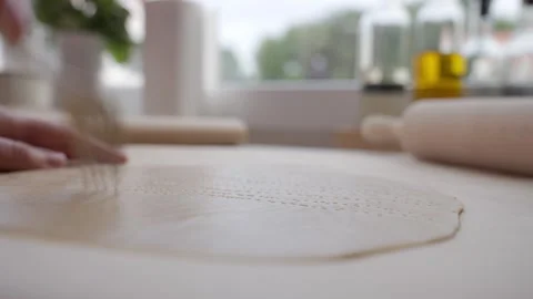 Hand pricks rolled dough with fork on kitchen counter Vídeos de archivo 337737550