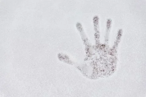 Hand print trace on snow capped floor Stock Photos